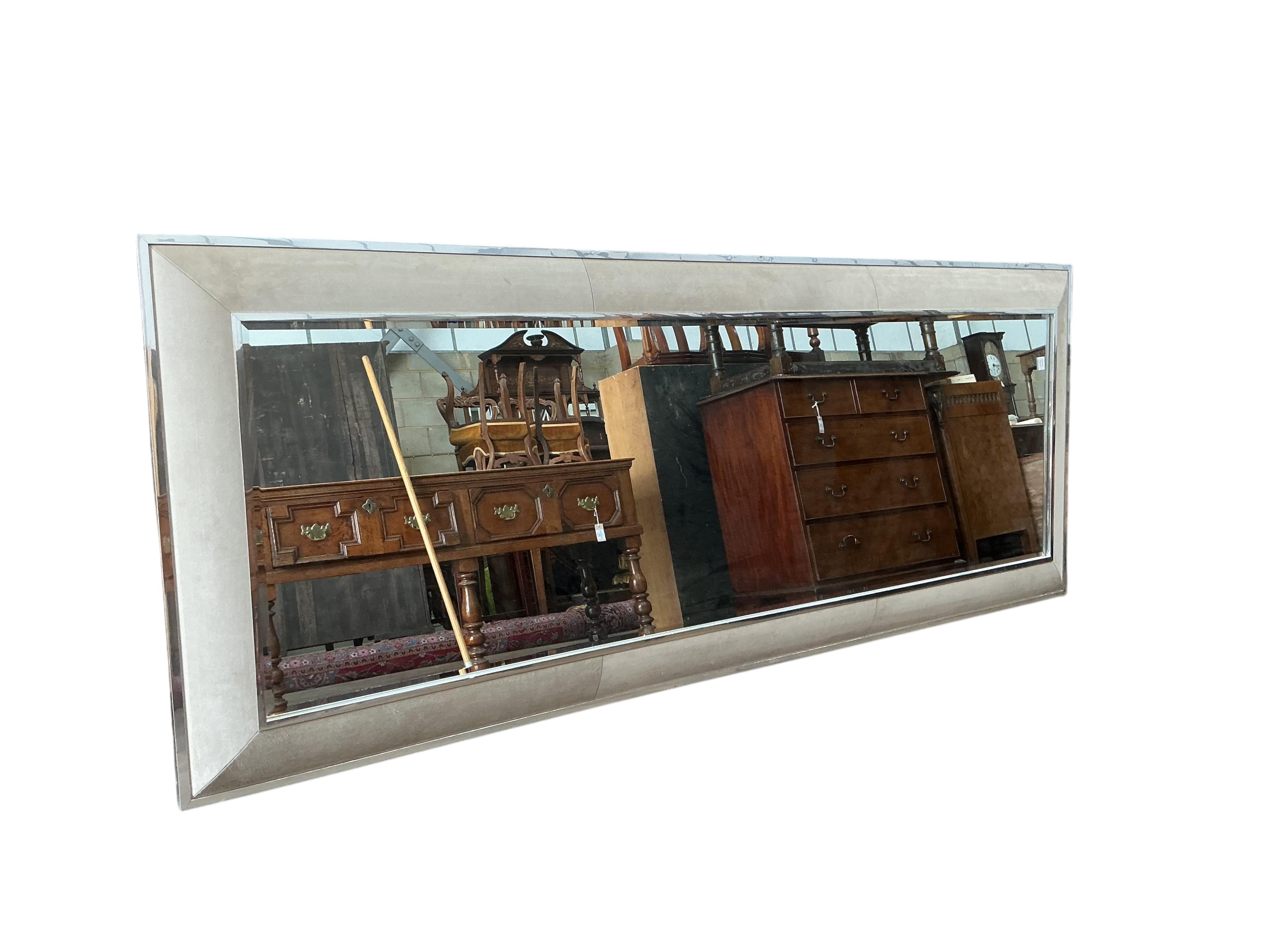 A large contemporary suede effect and chrome mirror, 280 x 100cm